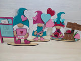 Three decorative gnomes with hearts and signs on a white background